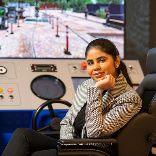 Picture of graduate student in the Drilling and Completion Simulation Facility.
