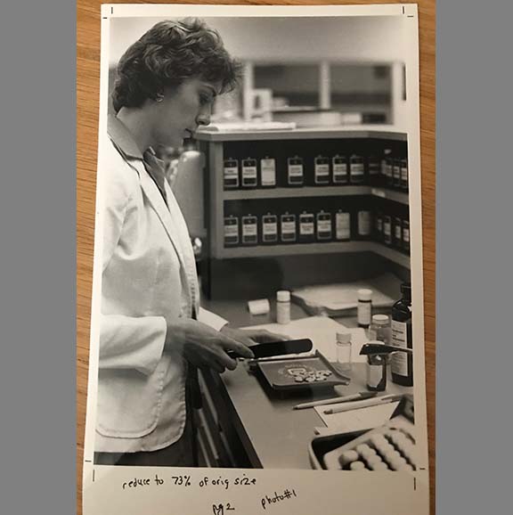 Student working in older UW School of Pharmacy lab.