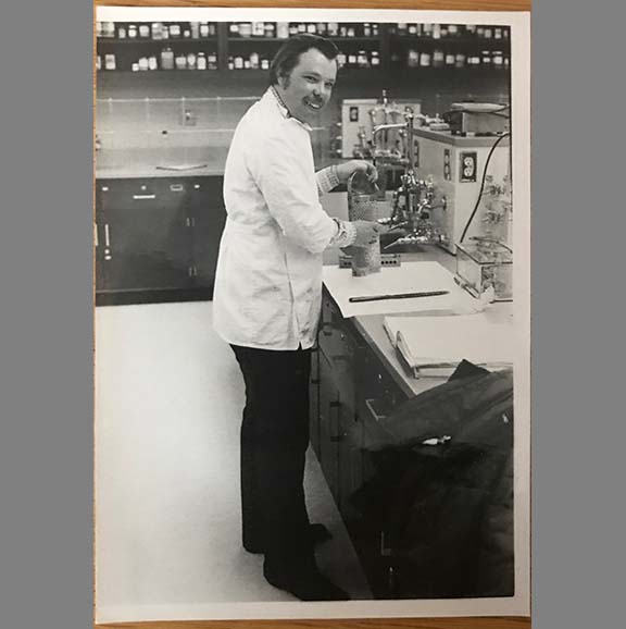 Student working in older UW School of Pharmacy lab.
