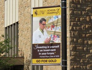 University of Wyoming School of Pharmacy alumna Jodi Johnson (Pharm.D. ’11) and Pharm.D. Candidate Forrest Floyd (class of 2015) are featured on banners in the UW Go for Gold Campaign. 