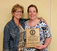 Jaime Hornecker (R), from Casper, Wyoming, is congratulated by Jennifer Nevins for being named the 2014 Pharmacist of the Year by the Wyoming Pharmacy Association. 