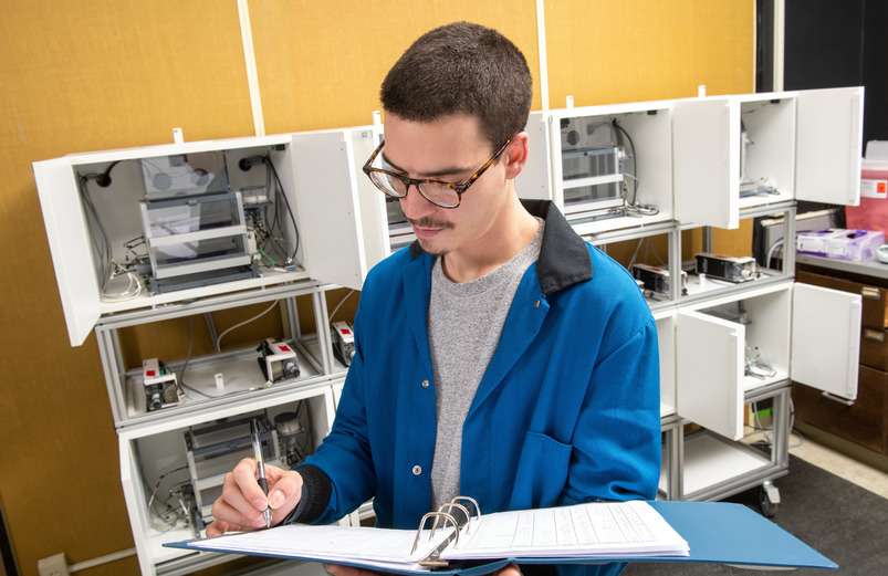 student takes notes in a lab