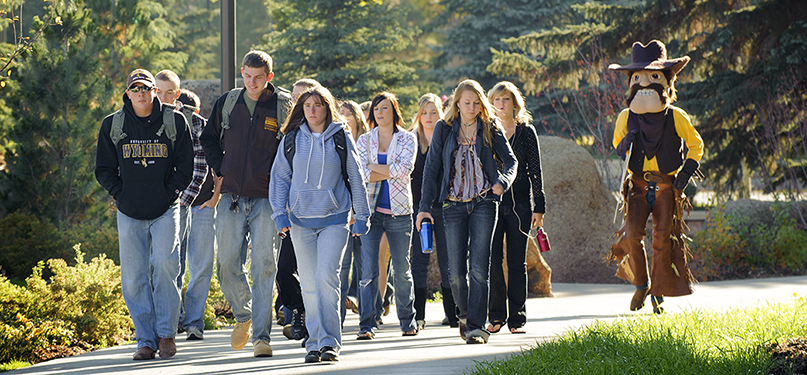 College students walking outside on an autumn day.