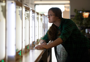 student looks at lab equipment