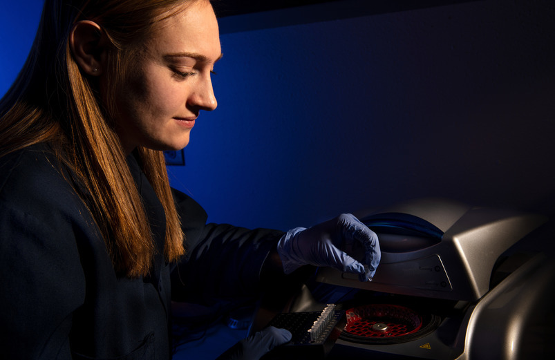 student works with lab equipment