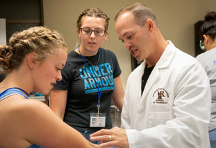 instructor working with students