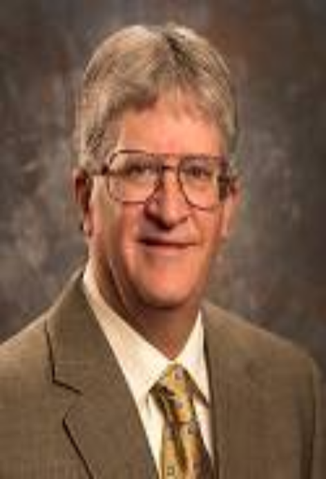 Smiling man with glasses in brown suit