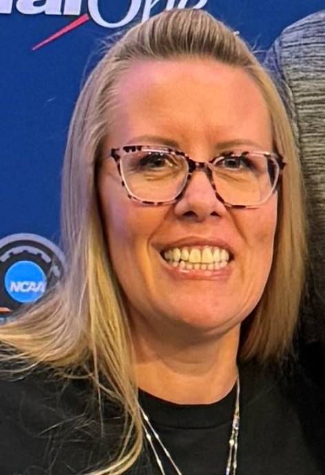 Smiling woman wearing glasses in black shirt