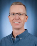 Man with Glasses  and wearing blue shirt