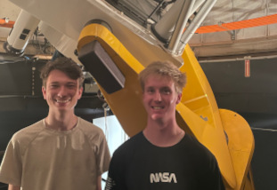 Two students in front of the telescope.  