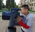photo of child looking through a telescope
