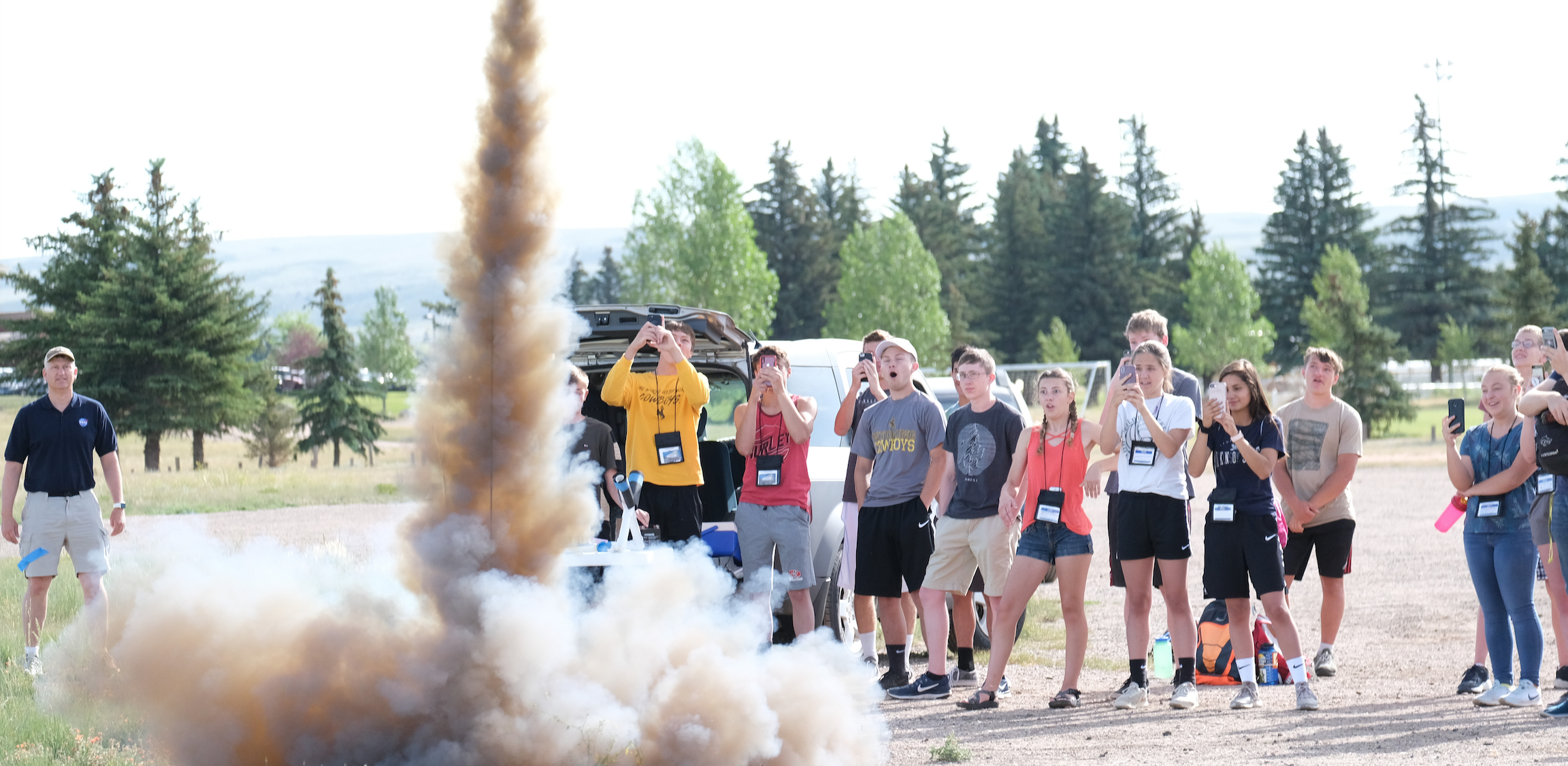photo of summer camp students launching a rocket