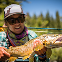 student holds brown trout