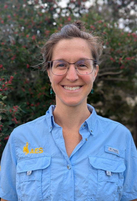 Smiling woman wearing blue AES shirt