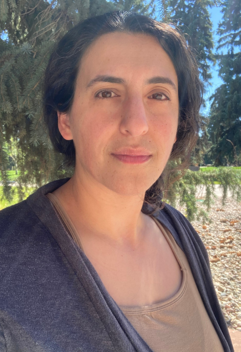 Woman outside wearing tank top and jacket