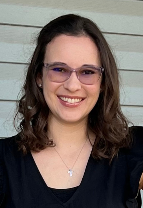 Smiling woman with glasses and black shirt