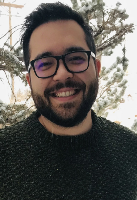 Smiling man with glasses outside