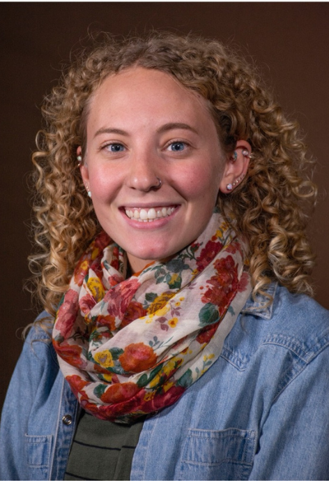 Smiling woman with curly hair and pretty scarf