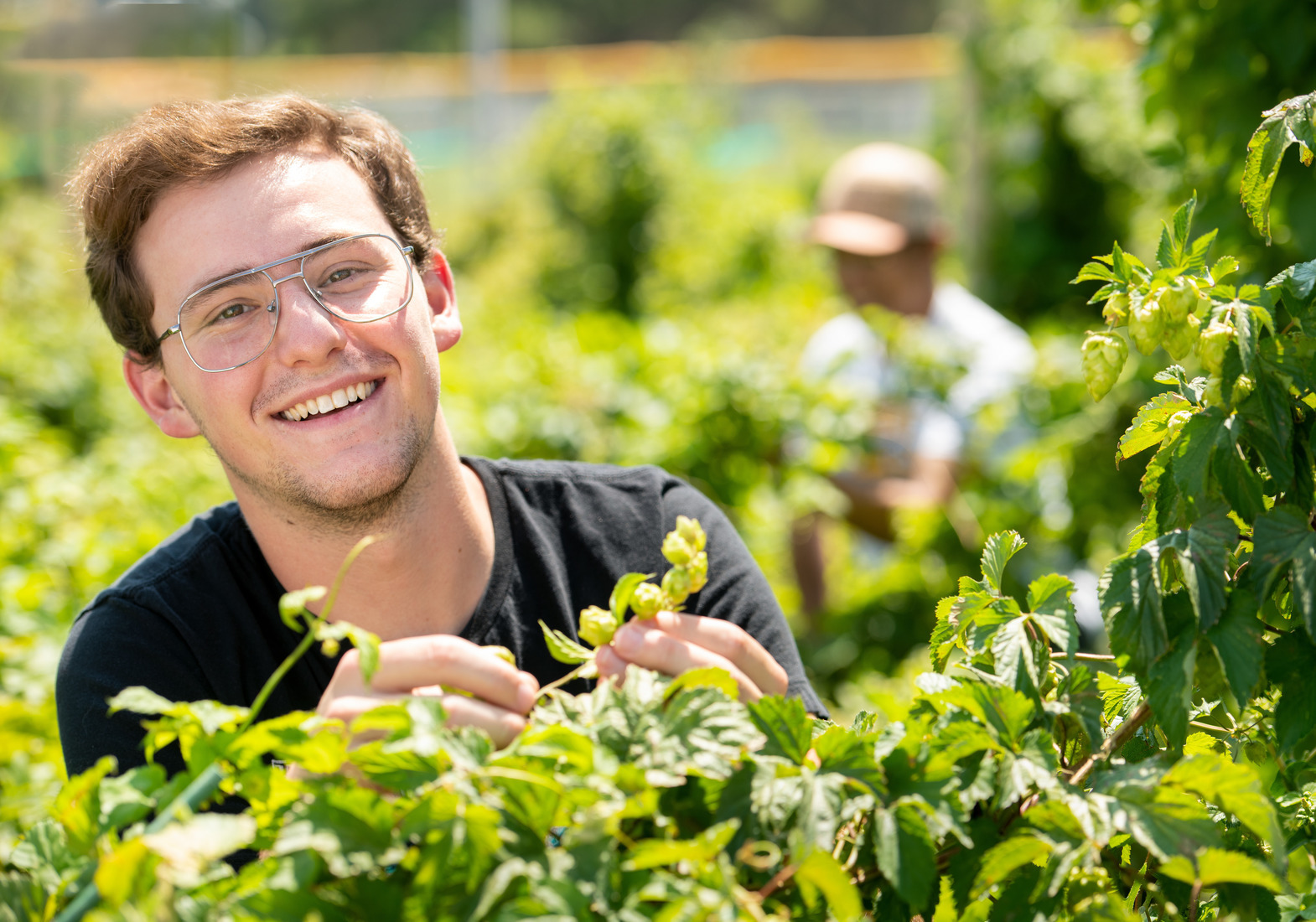 A student smiles out in a crop field