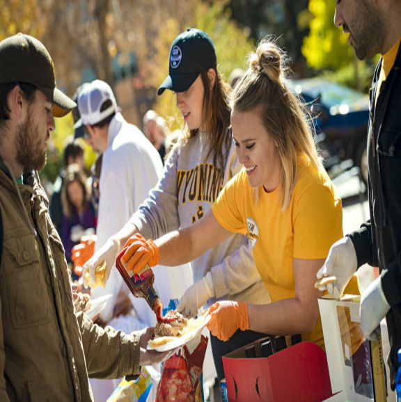 UW Student serving food at UW BBQ