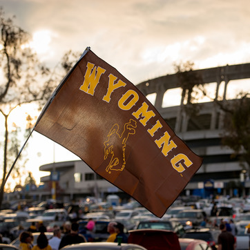 University of Wyoming flag in a stadium parking lot