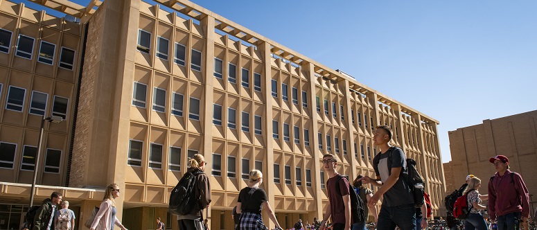 people walking past biuilding