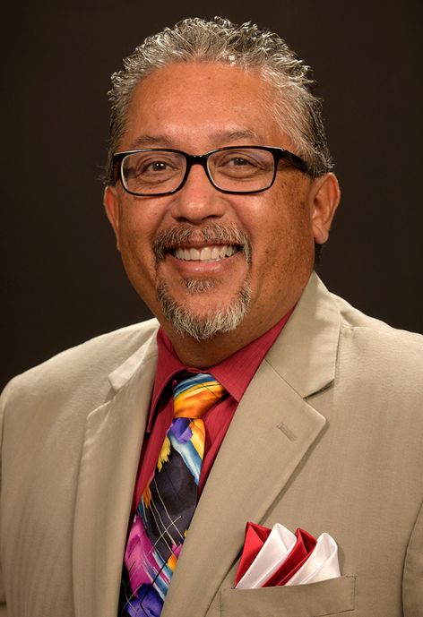 A man with a tan sports coat