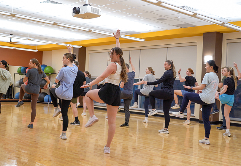 Students participate in a fitness dance class