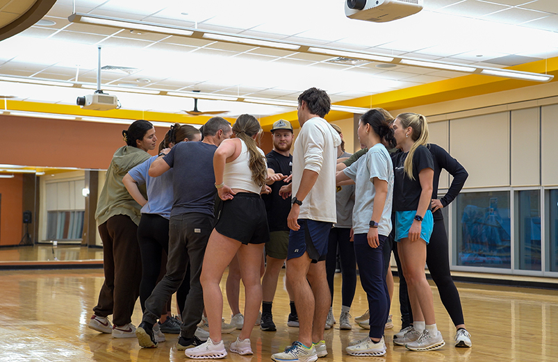 Fitness instructors huddle before a class
