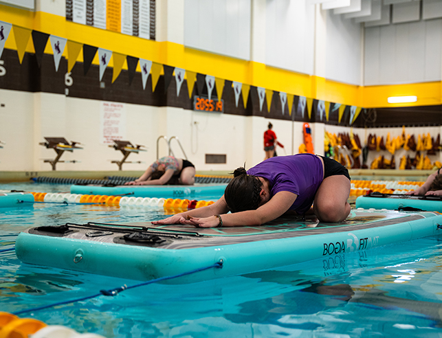 Participants practice stretching during a aquatics BogaFit class