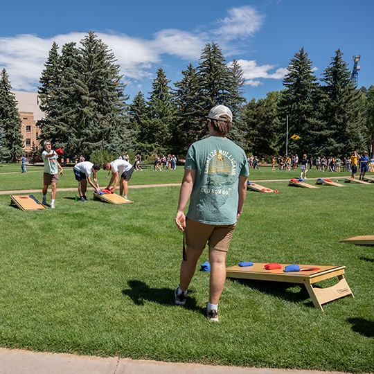 Students play bags in Prexy's Pasture