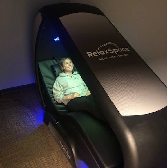A student uses the RelaxSpace Wellness Pod at Half Acre