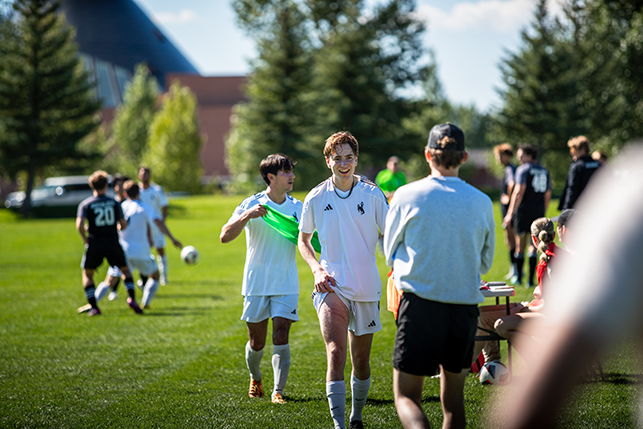 Men's soccer team members compete in a match in Laramie