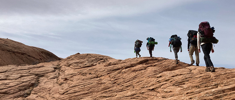 Students hiking along a mountain ridge