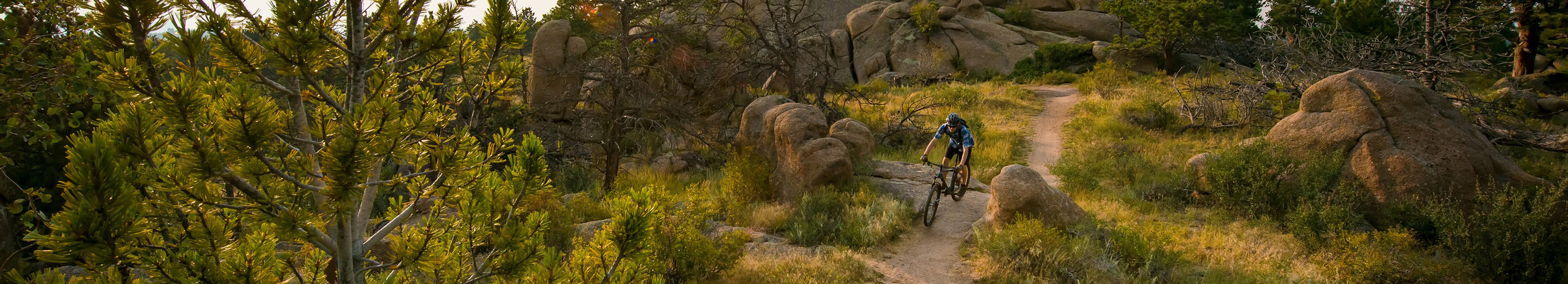 A student mountain bikes at Curt Gowdy State Park