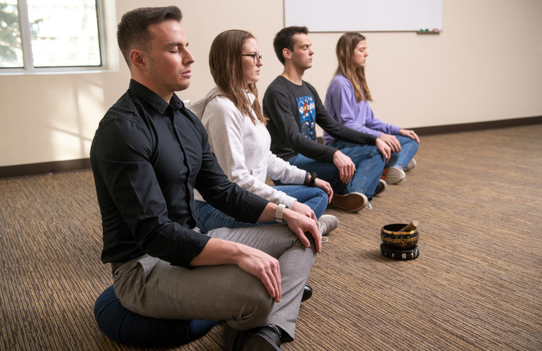 Patrons participate in meditation practice