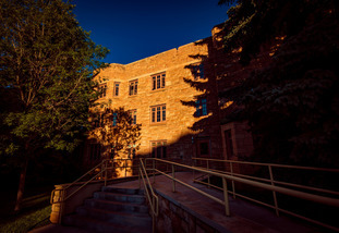 Knight Hall with the morning sun reflecting on the outside of the building