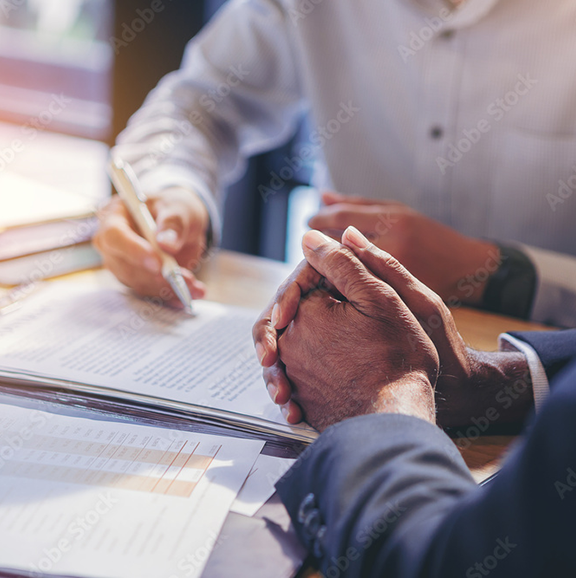Two people discussing paperwork at a table