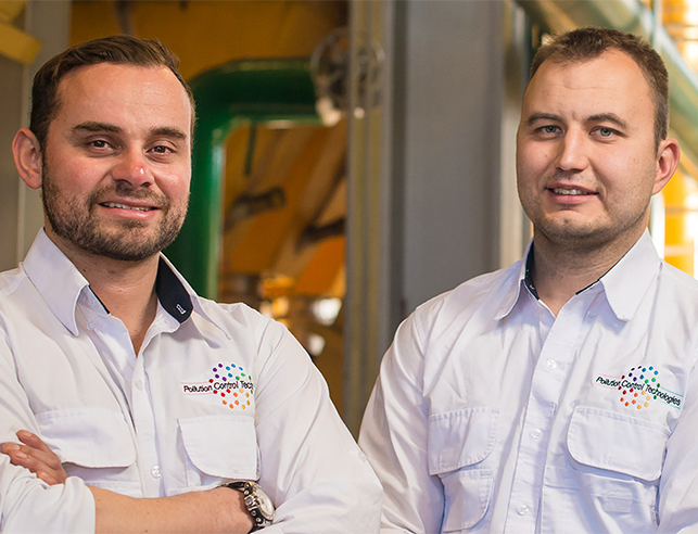 Two men standing in factory