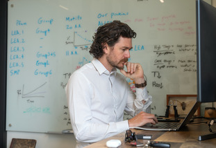 A UW community member looks over their research data on a computer.