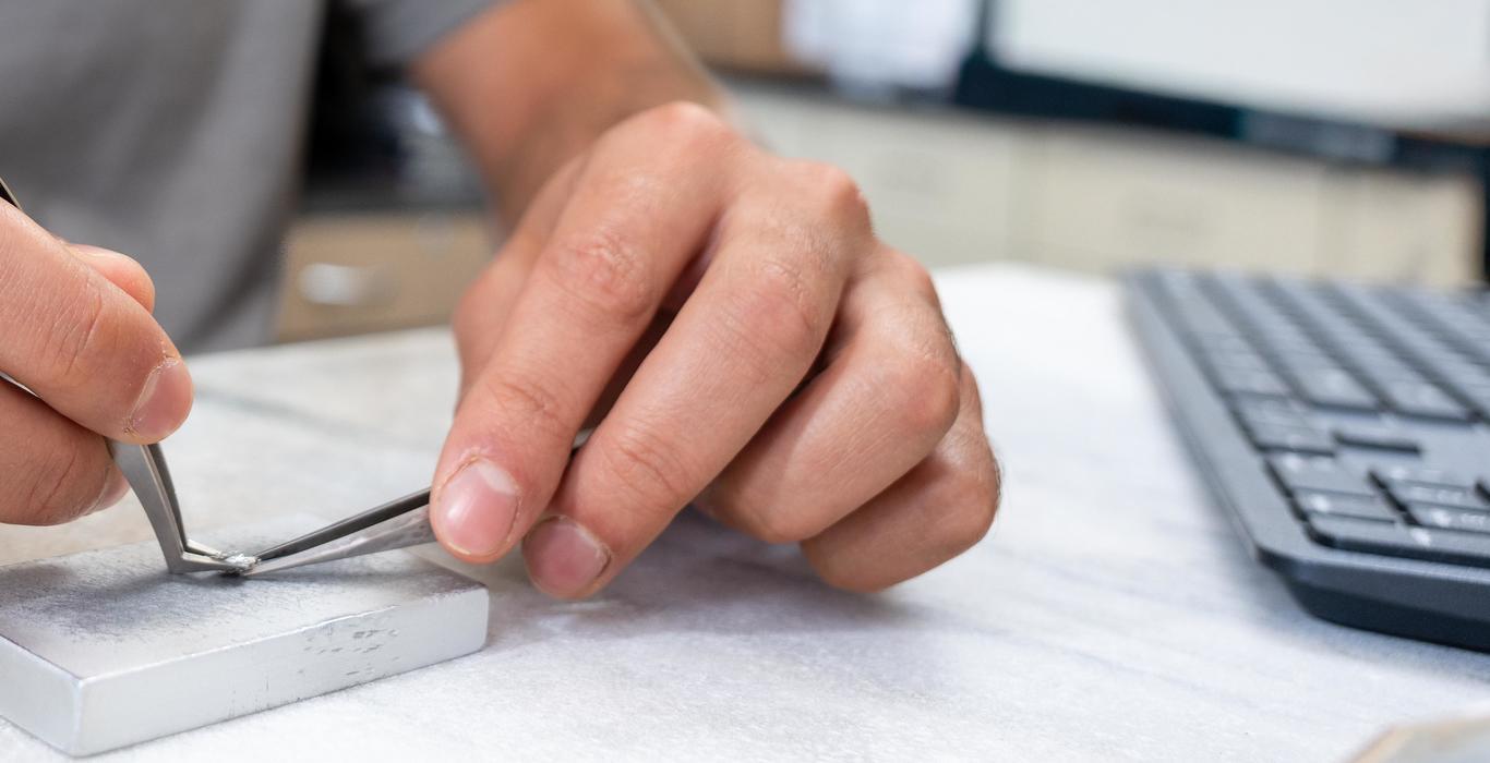 up close shot of hands holding tweezers