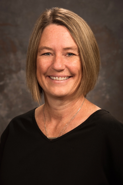 smiling woman with short hair and black shirt
