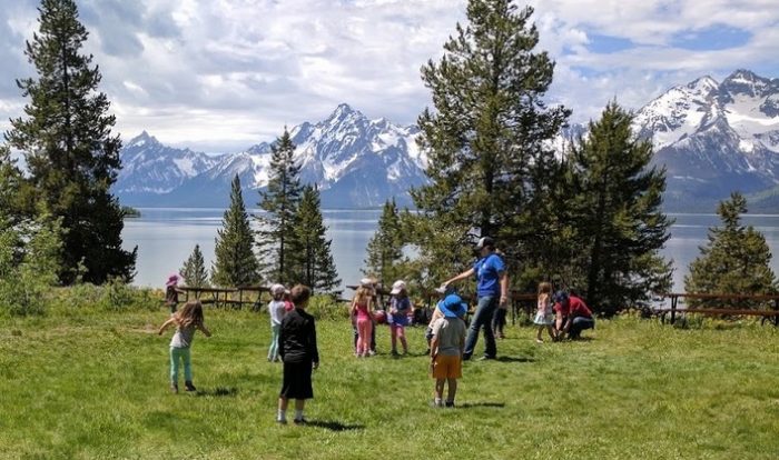 Image of a children's program held at AMK Ranch - children running in the grass