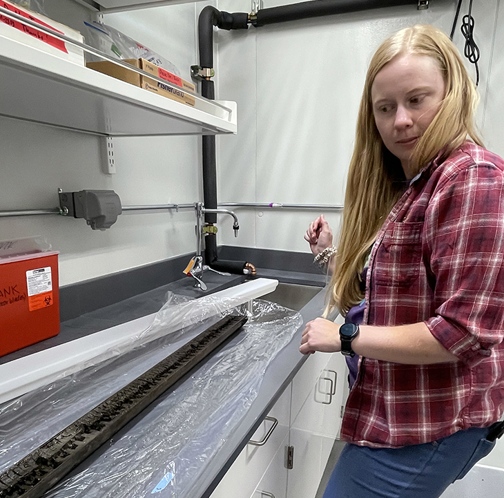 Sara with core sample in the lab