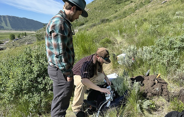 Trevor Bloom and Cory Ott examining soil at the Fire in the Mountain site, Jackson