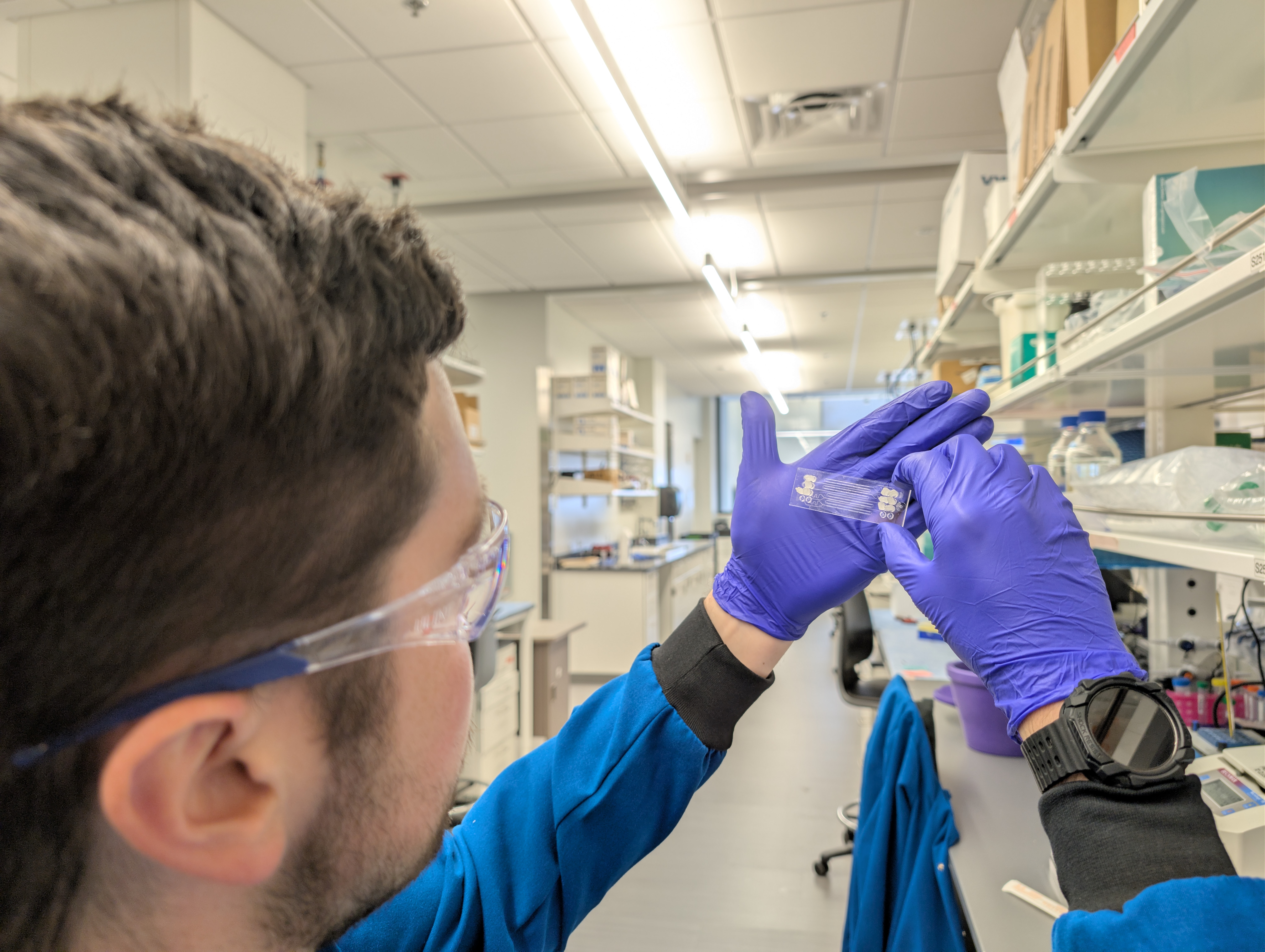student holding up microscope slide