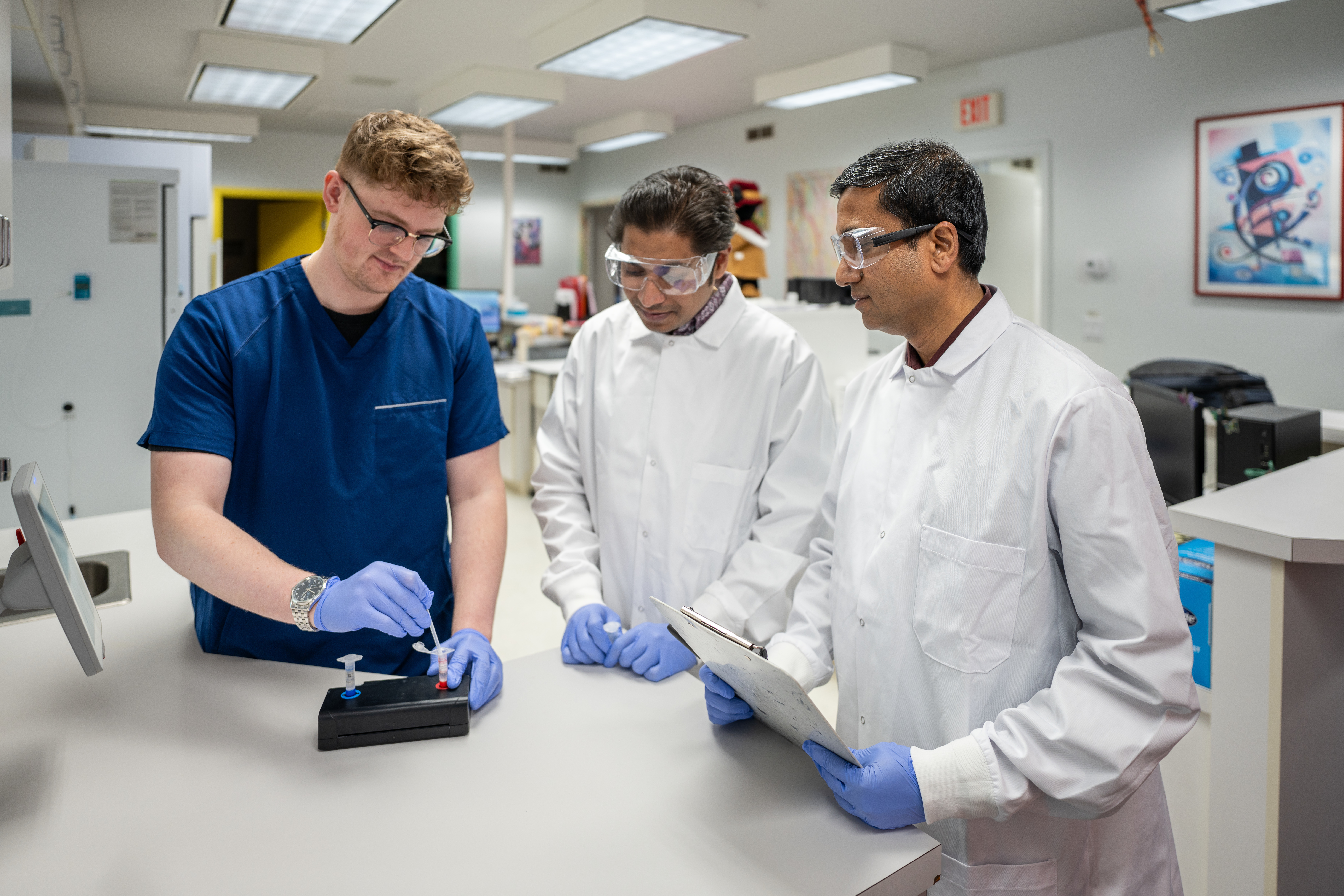 Professor Debashis Dutta and Chemistry Graduate student Amit Kumar Aehanzo are assisted in research at Laramie Pediatrics by Joshua Duckwitz