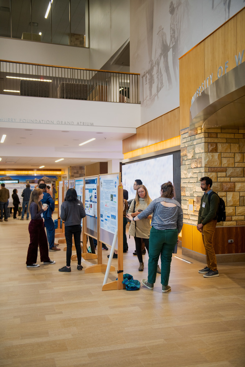 posters in hallway with people standing in front of them