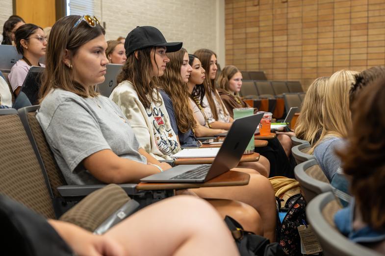 students in class with laptops