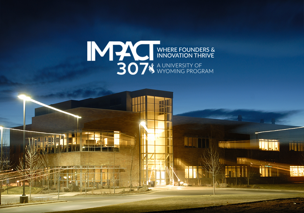 Wyoming Business Technology Center building at night with IMPACT 307 logo on top